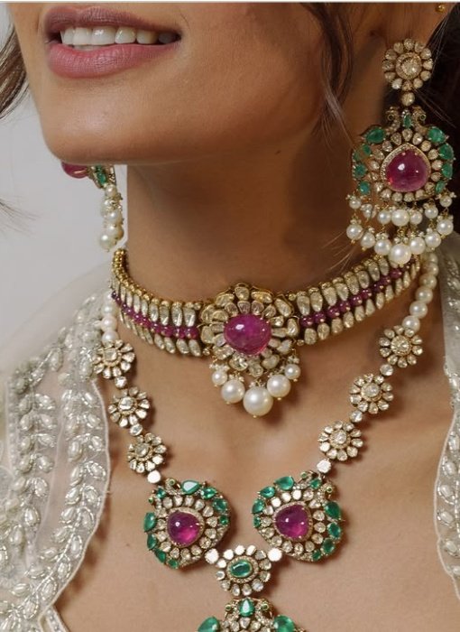 Ruby and emerald bridal necklace worn with ivory embroidery